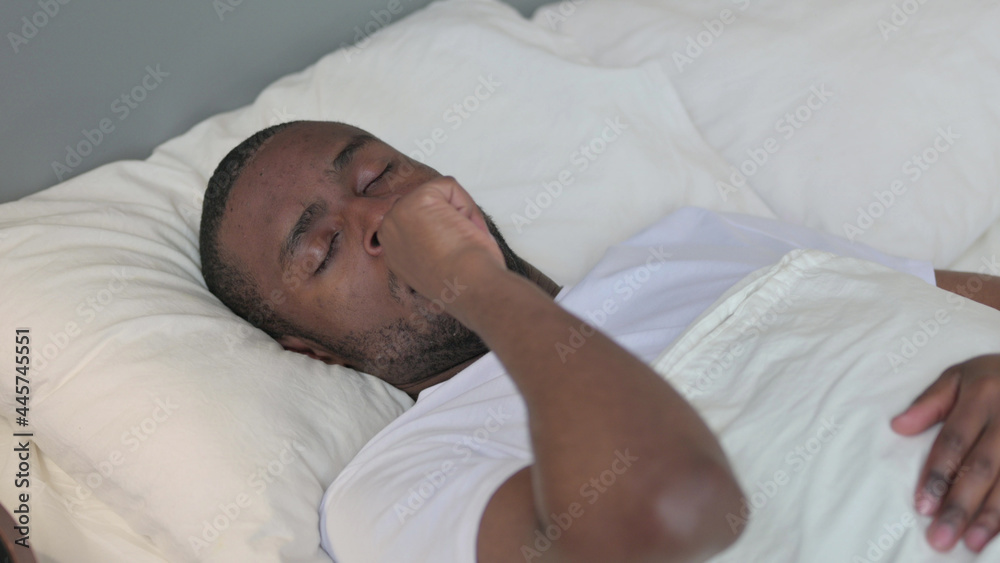 Young African Man with Cough Laying in Bed 