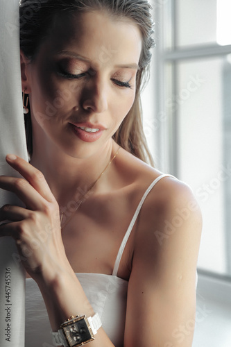 Portrait of cute adult style woman with make-up at window