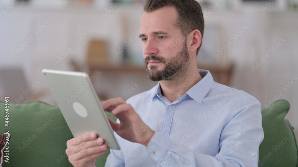 Young Man Using Tablet, Browsing Internet Young Man Using Tablet, Browsing Internet