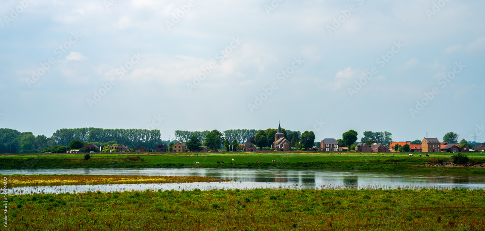 Panoramic view of a village on a river bank (river Meuse, Netherlands)
