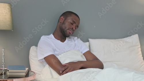 Sleepy Young African Man Taking Nap in Bed 