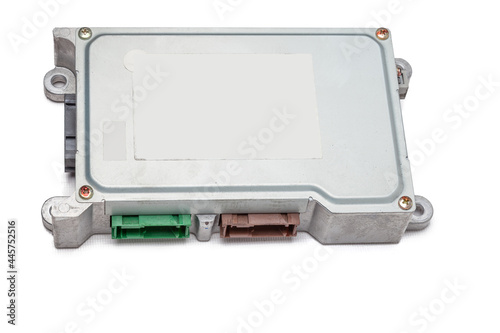 Metallic car engine control unit with plastic elements on a white isolated background is connecting center of various subsystems, units and assemblies. Monitoring the state of the moment. Spare part
