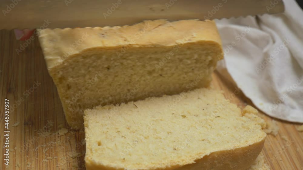 Homemade fresh baked organic bread being sliced Homemade fresh baked organic bread being sliced