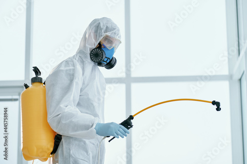 man in a bacteriological protection suit standing in the office .