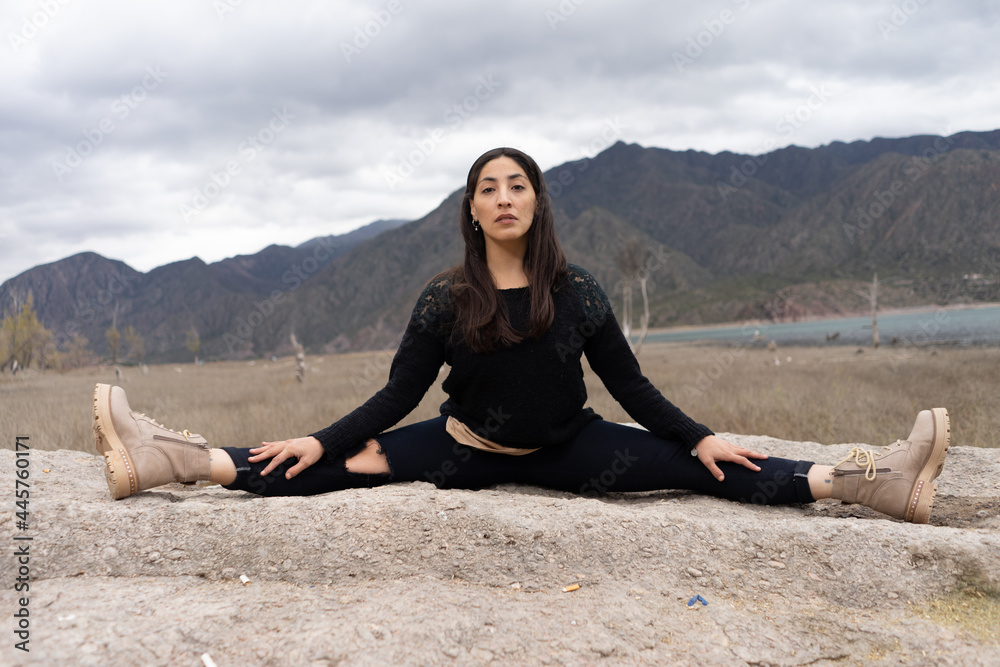 dancer opening legs on the cloudy mountain