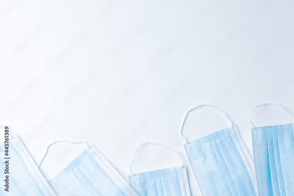 Top view blue medical mask on white background with copy space. Abstract texture blue mask protection coronavirus people wearing mask every time, and social distancing. Top view blue medical mask on white background with copy space. Abstract texture blue mask protection coronavirus people wearing mask every time, and social distancing.