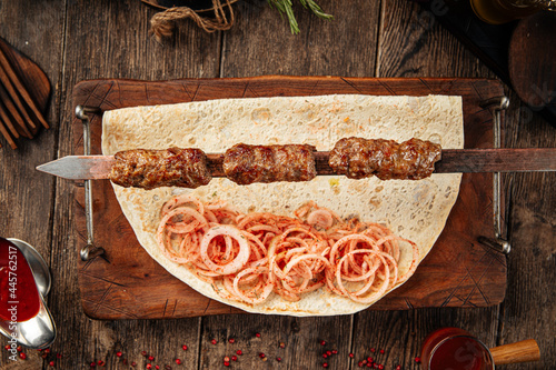 Caucasian beef lyulya kebab with marinated onion and lavash bread photo