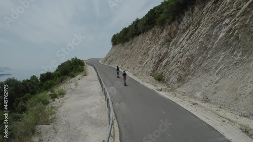 Man and Woman on the Electric Scooter Aerial Follow Scene in D-LOG 4K UHD Flat Format Ready for Grading