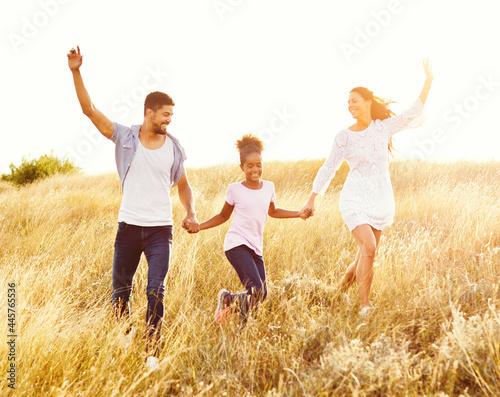 child daughter family happy mother father running active healthy carefree fun together girl walking cheerful field outdoor nature summer