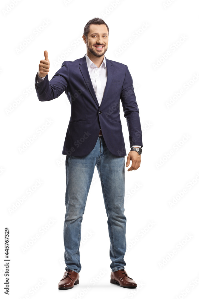 Full length portrait of a man in jeans and suit standing and showing thumbs up Full length portrait of a man in jeans and suit standing and showing thumbs up