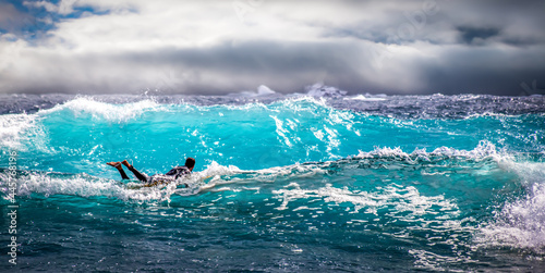 A surfer surfing in a rough sea
