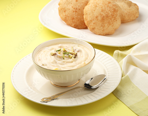 Indian dessert Shrikhand served with hot puri