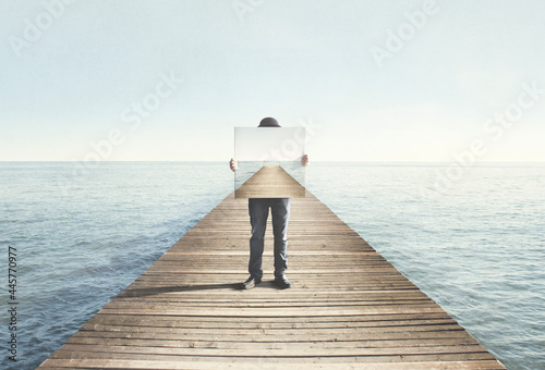 Man holding surreal painting of a boardwalk, abstract concept