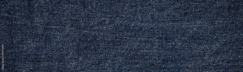 Naklejka premium texture of blue jeans denim fabric background