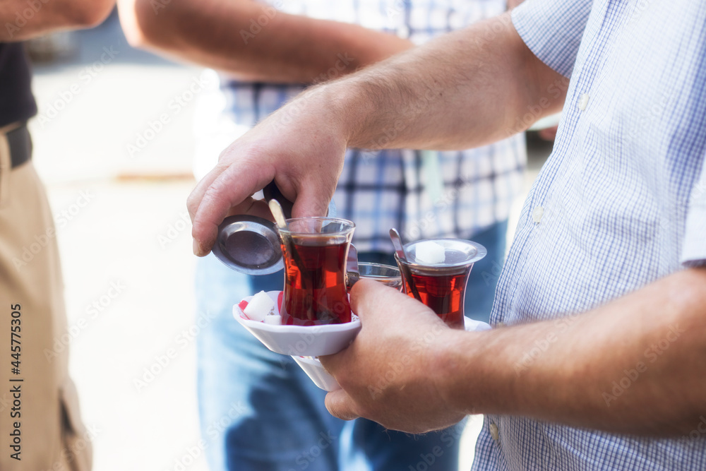 The seller serves three Turkish teas. Stock photo. The seller serves three Turkish teas. Stock photo.