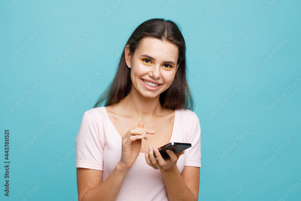 Pretty girl with smartphone in hands addicted to social media. Portrait of smiling young woman browsing on telephone. Female expresses joyful emotions. Pretty girl with smartphone in hands addicted to social media. Portrait of smiling young woman browsing on telephone. Female expresses joyful emotions.