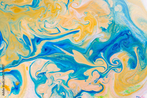 Fluid art blue yellow pattern. Abstract ink mixed texture. Psychedelic multicolored background