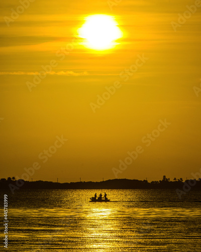 sunset over the sea boat silhouette 