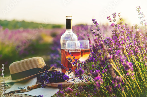 Wine in glasses. Picnic in the lavender field. Selective focus. photo