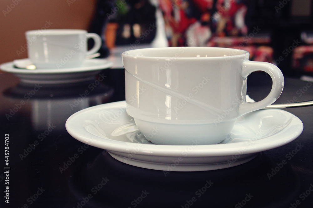 plain little white cup with hot drink in cafe plain little white cup with hot drink in cafe