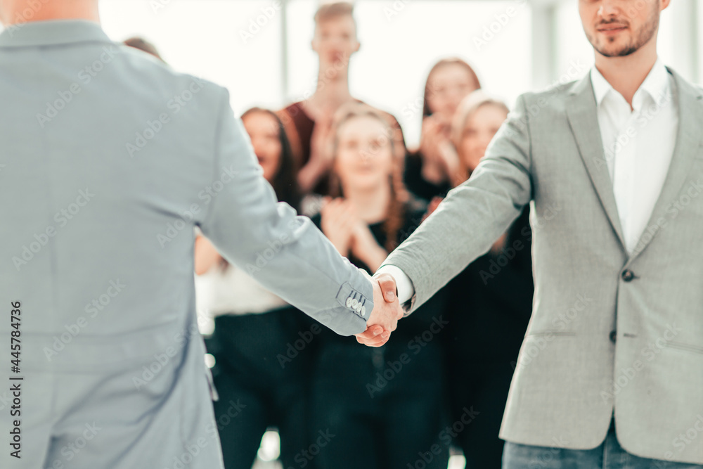 close up. young people confidently shaking hands