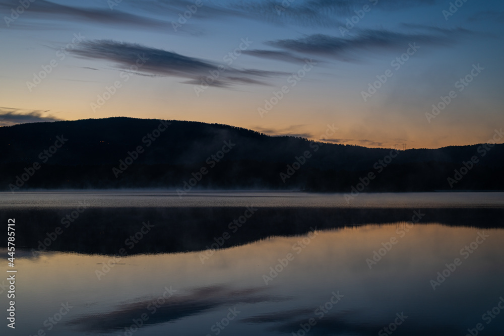 the morning sky over the fjord Tinnsjå is  colored by the sun