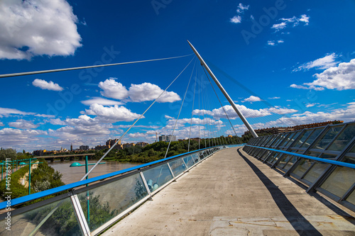 pedestrian suspension bridge over the Ebro river in Zaragoza, Spain on a summer day