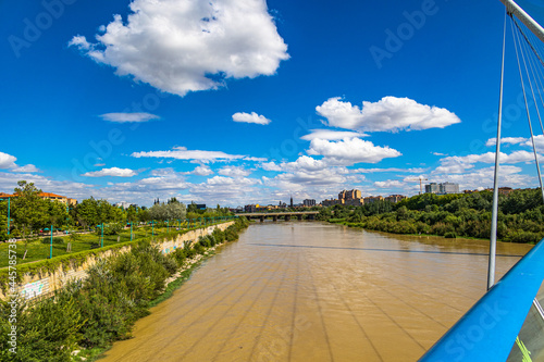  summer landscape on a sunny day view of the Ebro river and bridges in Zaragoza, Spain