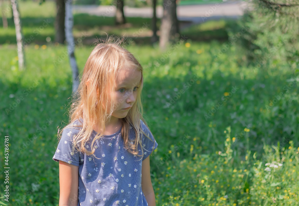 little girl, blonde six years old, with a displeased face, against the background of nature, portrait of a preschooler, with surprised eyes little girl, blonde six years old, with a displeased face, against the background of nature, portrait of a preschooler, with surprised eyes