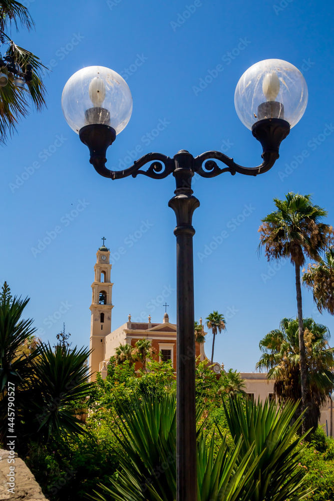 Big lantern and View of the St. Peter's Church, bell tower of the Saint Peter Church in Old Jaffa in Tel Aviv Yaffo, Israel