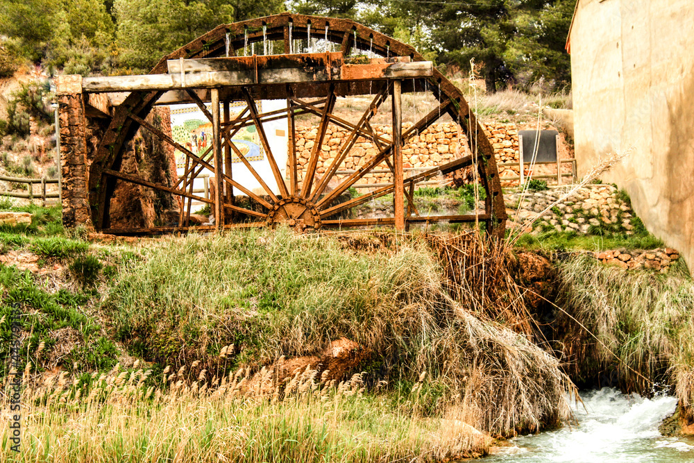 Old wooden waterwheel and Cabriel River on its way through Casas del Rio village, Albacete, Spain.