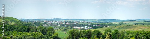 Beautiful summer countryside landscape in Ukraine, forest field and village