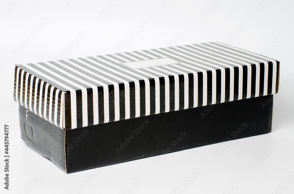 A shoe box neatly placed against a white isolated background, showcasing a clean and minimalistic presentation