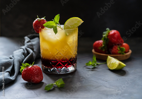 Cocktail with strawberry  lemon and orange juice