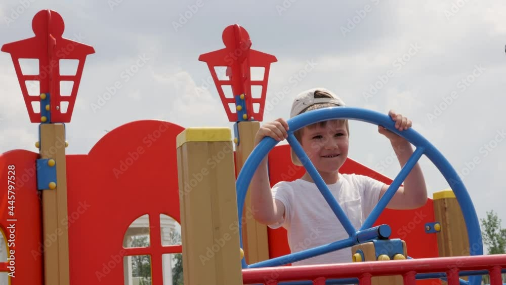 Child captain at helm boat playground wooden ship in park game pirate ...