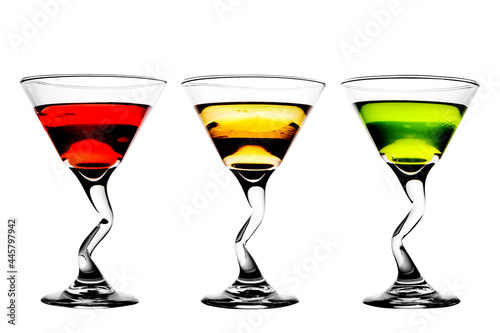 Three alcoholic beverages of red, yellow and green colors on a white background (isolated).