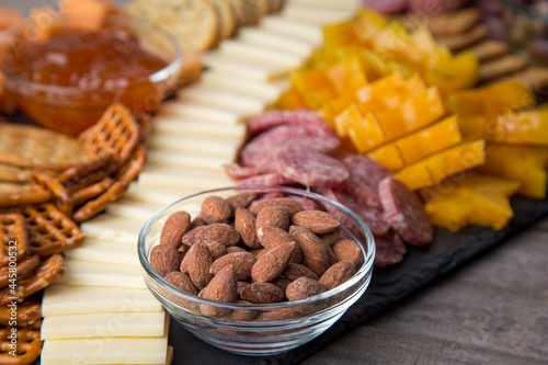 Full platter with meats, cheese, nuts, crackers, olives and an apricot spread