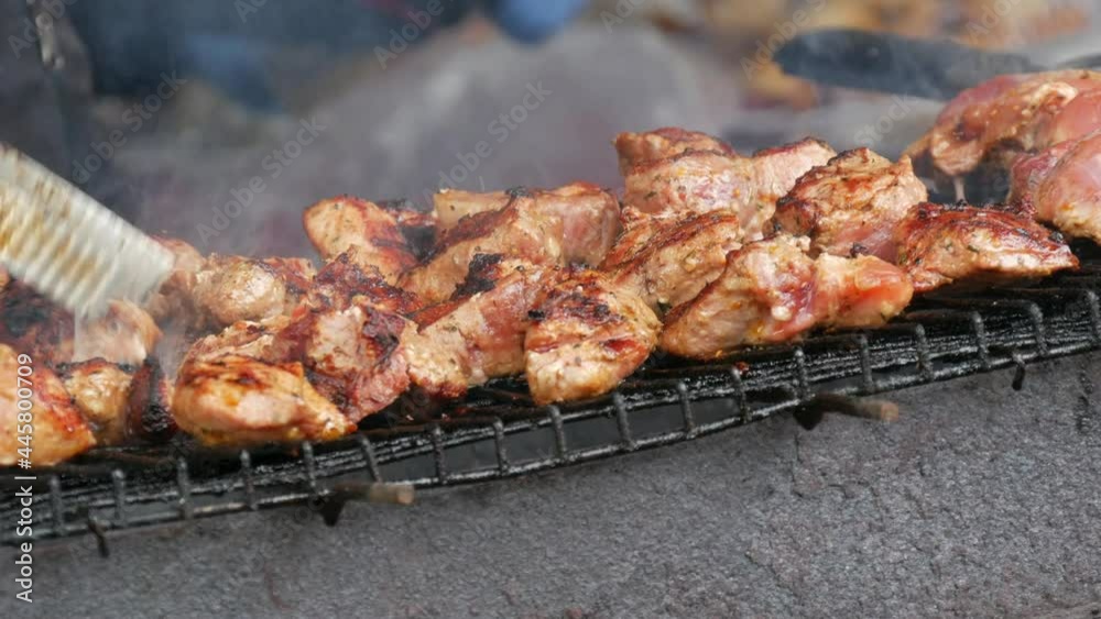 Close-up of grilling dish on barbecue. Process of cooking shashlik in nature. Delicious food on metal skewer in bbq. Time to picnic concept. Street food. Food festival. Pork at the stake. Fried pork. Close-up of grilling dish on barbecue. Process of cooking shashlik in nature. Delicious food on metal skewer in bbq. Time to picnic concept. Street food. Food festival. Pork at the stake. Fried pork.