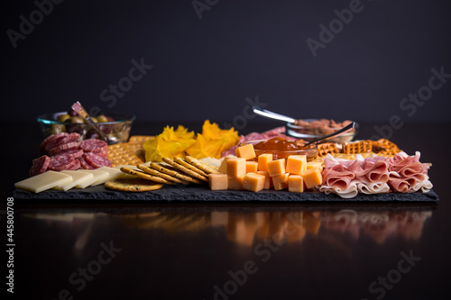 Full platter with meats, cheese, nuts, crackers, olives and an apricot spread