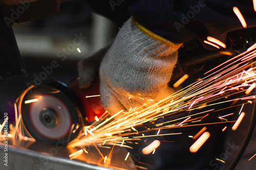 Metal workers use manual labor. Technicians use steel cutting tools to cut steel. Metal cutting. content work safety. builder wear fireproof gloves for safety at work.