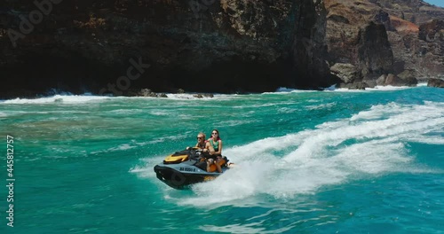 Epic jet ski ride, couple riding jet ski in front of amazing tropical island