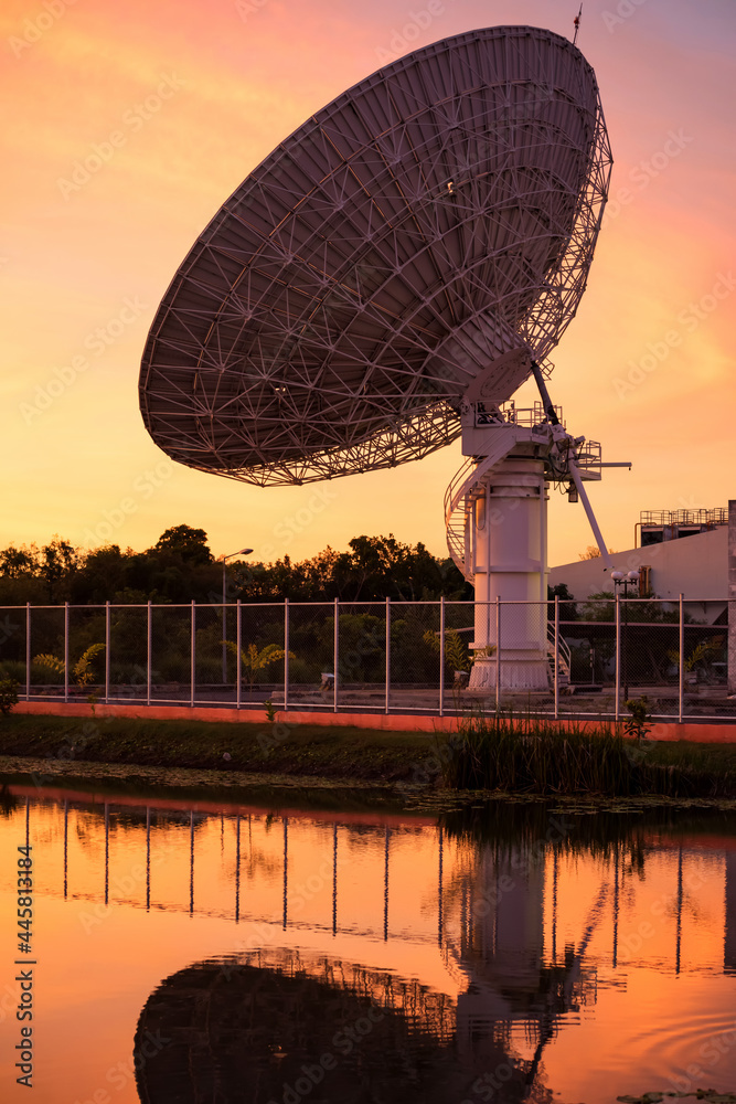 Large satellite dish at dusk with reflection