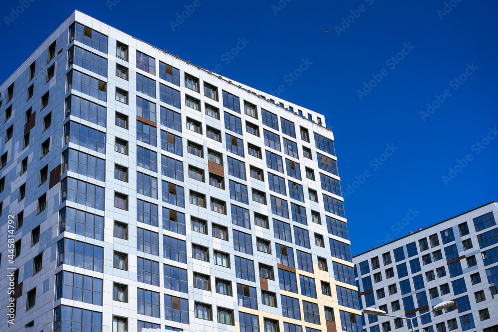 beautiful facades of high-rise buildings against the blue sky on a sunny day beautiful facades of high-rise buildings against the blue sky on a sunny day
