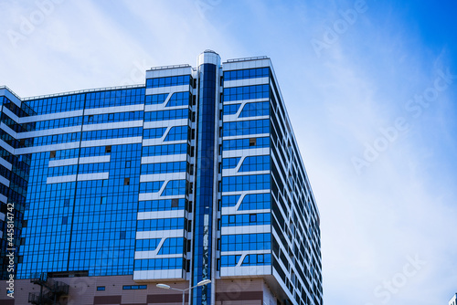 beautiful facades of high-rise buildings against the blue sky on a sunny day