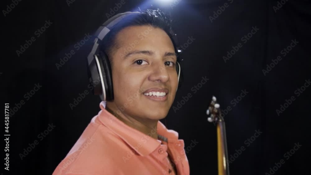 Adult multi-racial man singing and playing the guitar in a studio in 4K Adult multi-racial man singing and playing the guitar in a studio in 4K