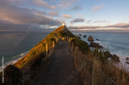 Nugget Point Lighthouse in the Catlins New Zealand at sunset photo