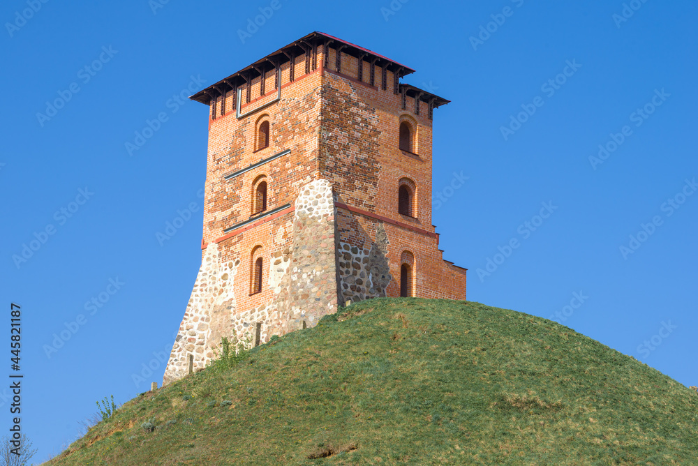 The restored tower of the ancient medieval castle on a sunny April day. Novogrudok, Belarus