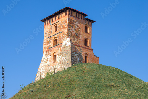 The restored tower of the ancient medieval castle on a sunny April day. Novogrudok, Belarus © sikaraha