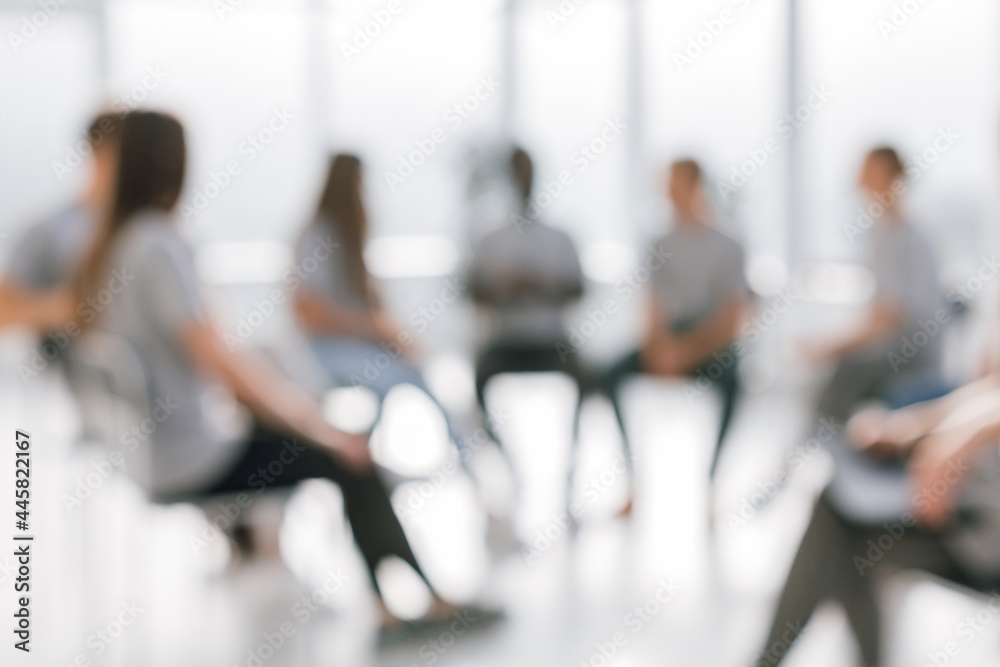 background image of a group of young people sitting in a circle