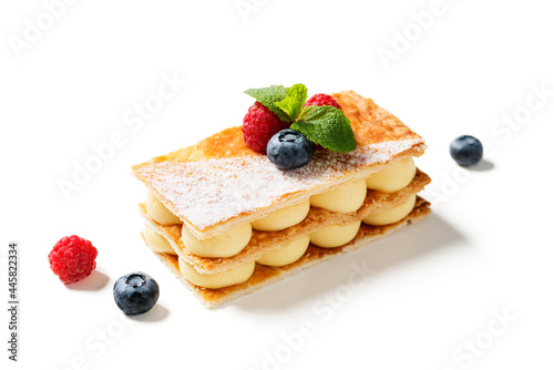 Classic french dessert millefeuille with vanilla cream and fresh berries. isolated on white background photo